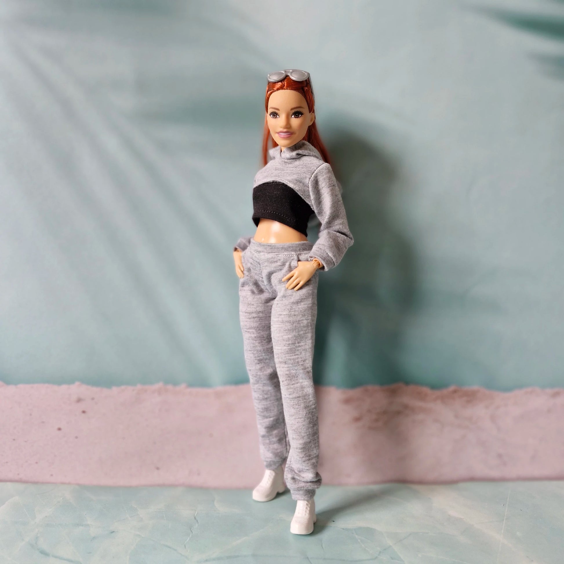 Two Barbie dolls wearing matching pink and white streetwear outfits in curvy and regular sizes