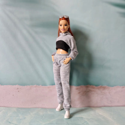 Two Barbie dolls wearing matching pink and white streetwear outfits in curvy and regular sizes