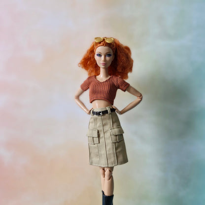 Redhead Barbie doll with sunglasses wearing rust orange top and beige cargo mini skirt