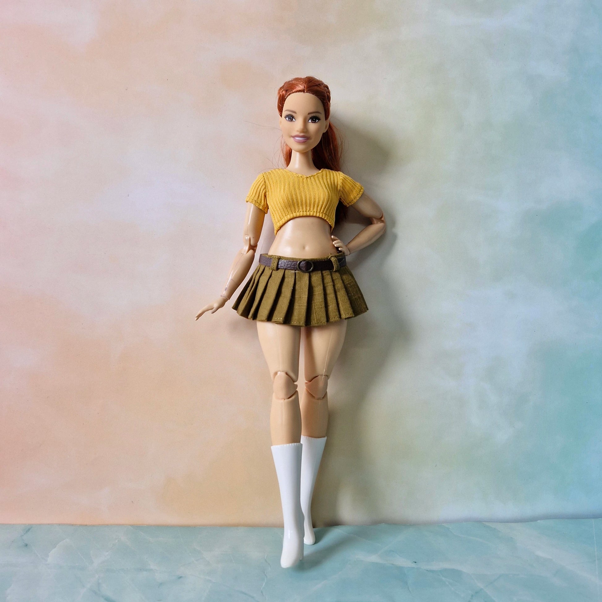 Curvy Barbie style doll standing wearing yellow monochromatic skirt and top set