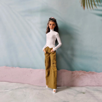 Brunette Barbie doll wearing white turtleneck top and olive brown cargo pants