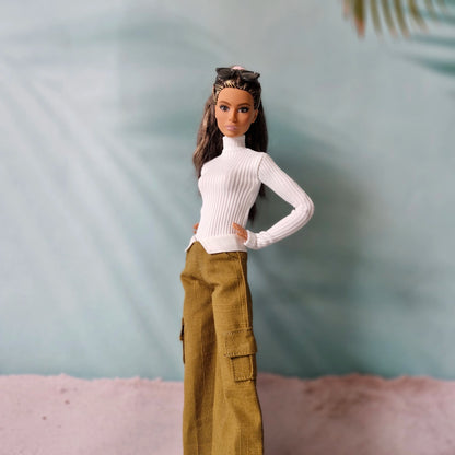 Fashion doll posing in white ribbed long sleeve shirt and brown wide leg trousers