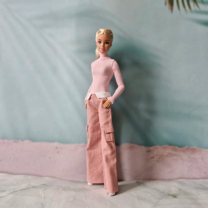 Blonde Barbie doll wearing pink turtleneck top and pink wide leg cargo pants