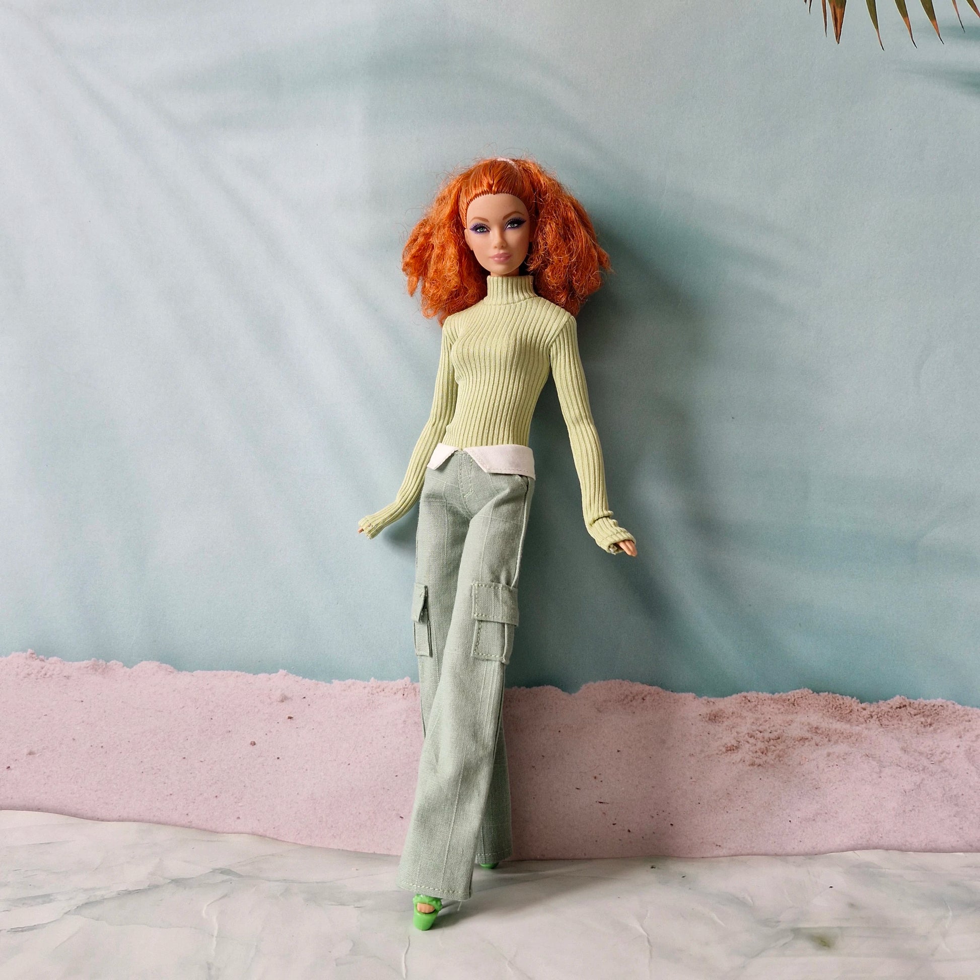 Redhead Barbie doll wearing sage green turtleneck and matching green cargo pants