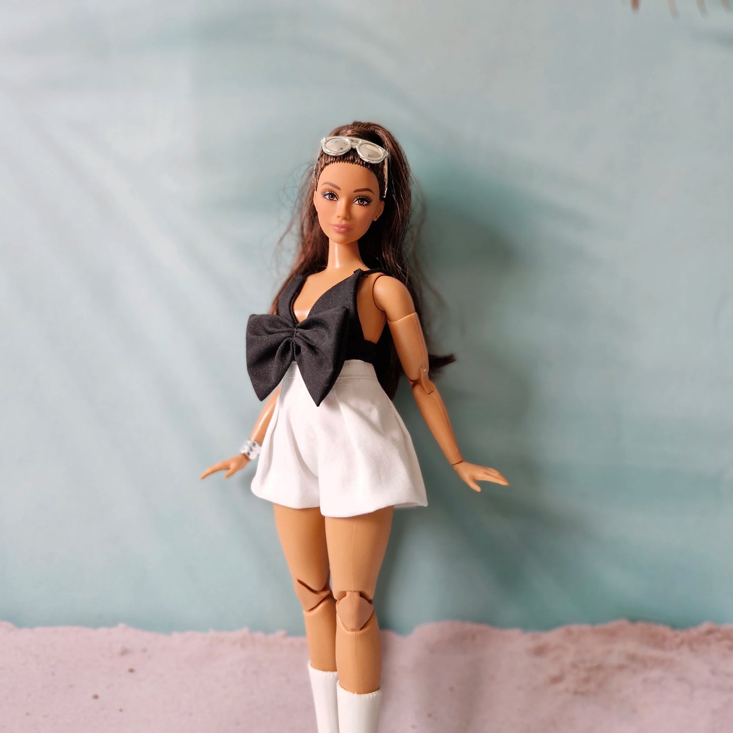 Curvy Made to Move doll modeling a cute black and white romper outfit