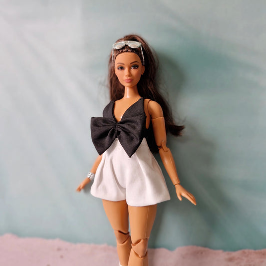 Close up detail of oversized black bow on Curvy doll romper fashion
