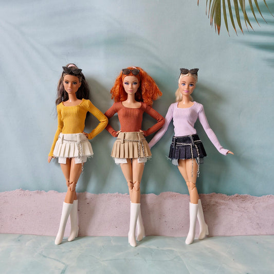 Collection of three fashion dolls wearing trendy Y2K separates in yellow orange and purple