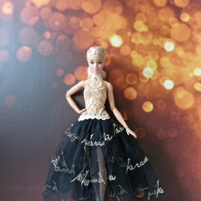 Barbie doll in an elegant high-fashion dress with gold lace and embroidered black tulle
