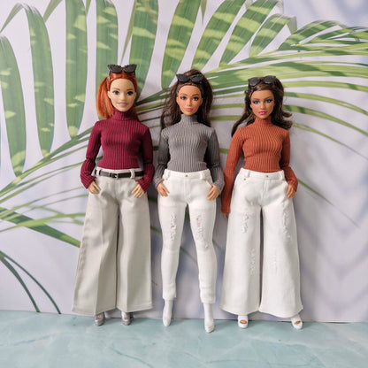 Three Curvy fashion dolls posing in trendy ribbed sweaters and diverse white and beige trousers