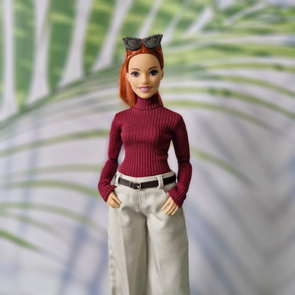 Curvy Barbie doll wearing a burgundy ribbed turtleneck sweater and wide-leg pants