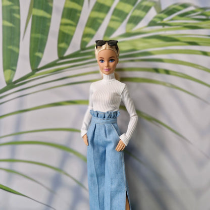 Barbie doll wearing a white turtleneck and light blue paperbag waist wide leg jeans with side slits