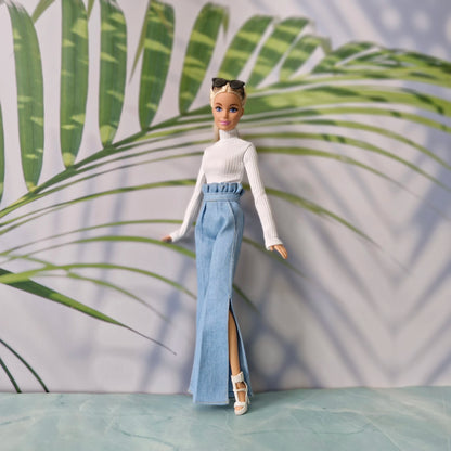 Blonde Barbie doll posing in trendy light wash jeans and white knit top outfit