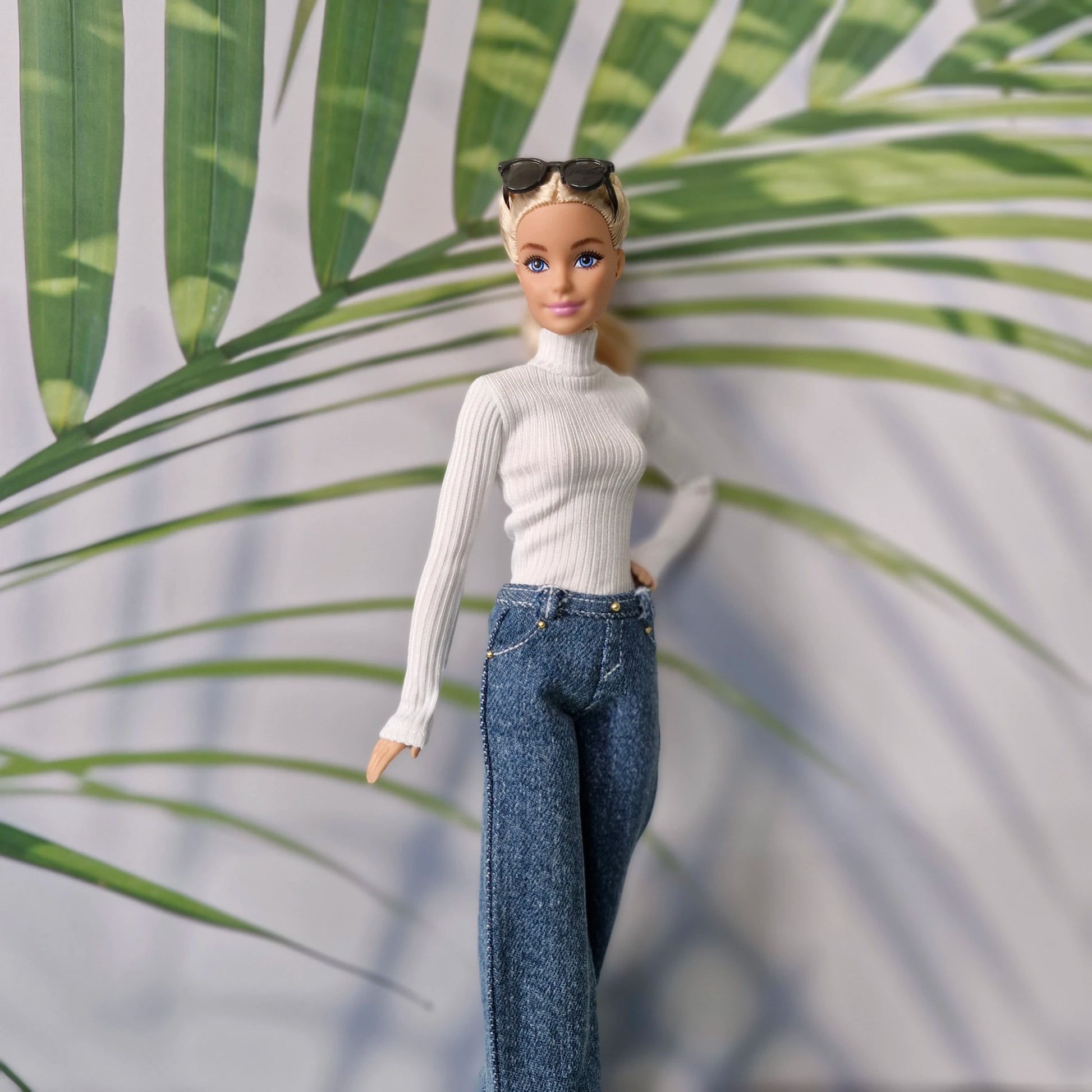 Barbie fashion doll modeling casual streetwear separates with dark blue jeans and white turtleneck