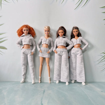 Group of four Barbie dolls wearing different styles of grey loungewear outfits