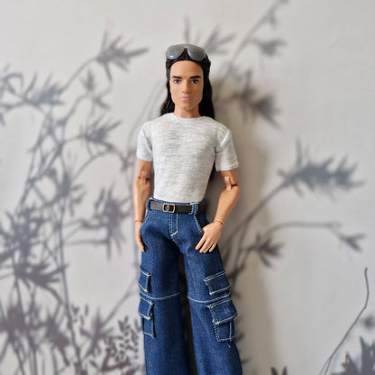 Close up portrait of Ken doll dressed in a stylish grey tee and dark blue denim cargo jeans