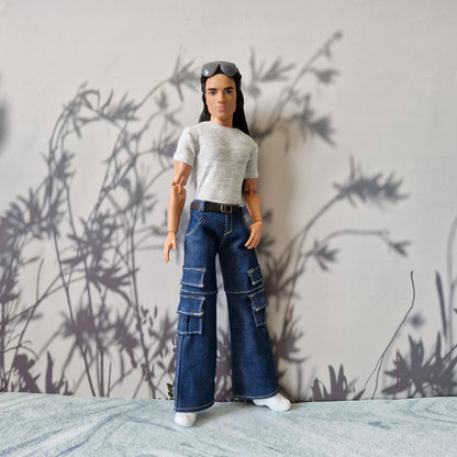 Ken doll posing in trendy streetwear including a grey t-shirt and baggy denim cargo pants