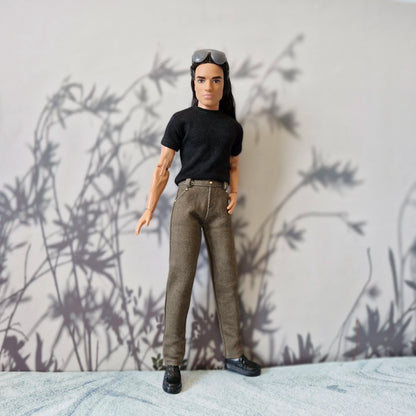 Front view of Ken doll dressed in everyday casual wear black tee and brown trousers