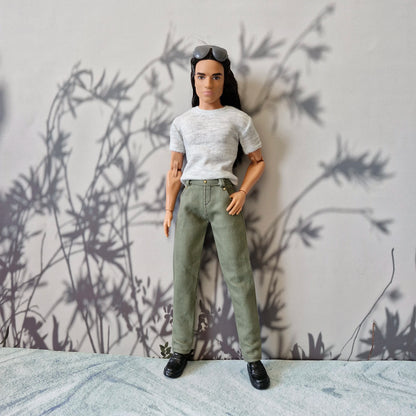 Ken doll modeling a heather grey short sleeve t-shirt and slim fit olive green trousers
