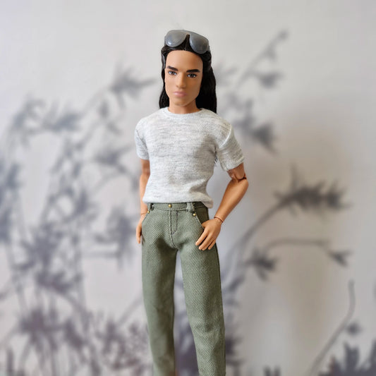 Close up portrait of Ken doll dressed in a casual grey tee and stylish olive green pants