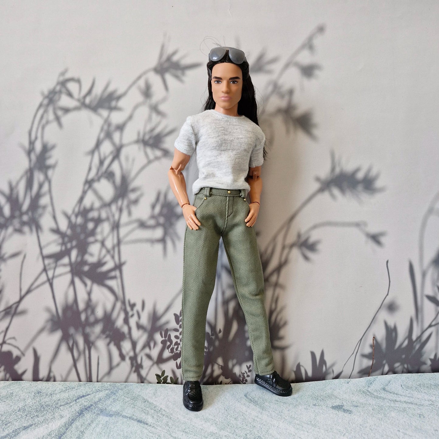 Front view of Ken doll looking stylish in everyday casual grey tee and olive pants