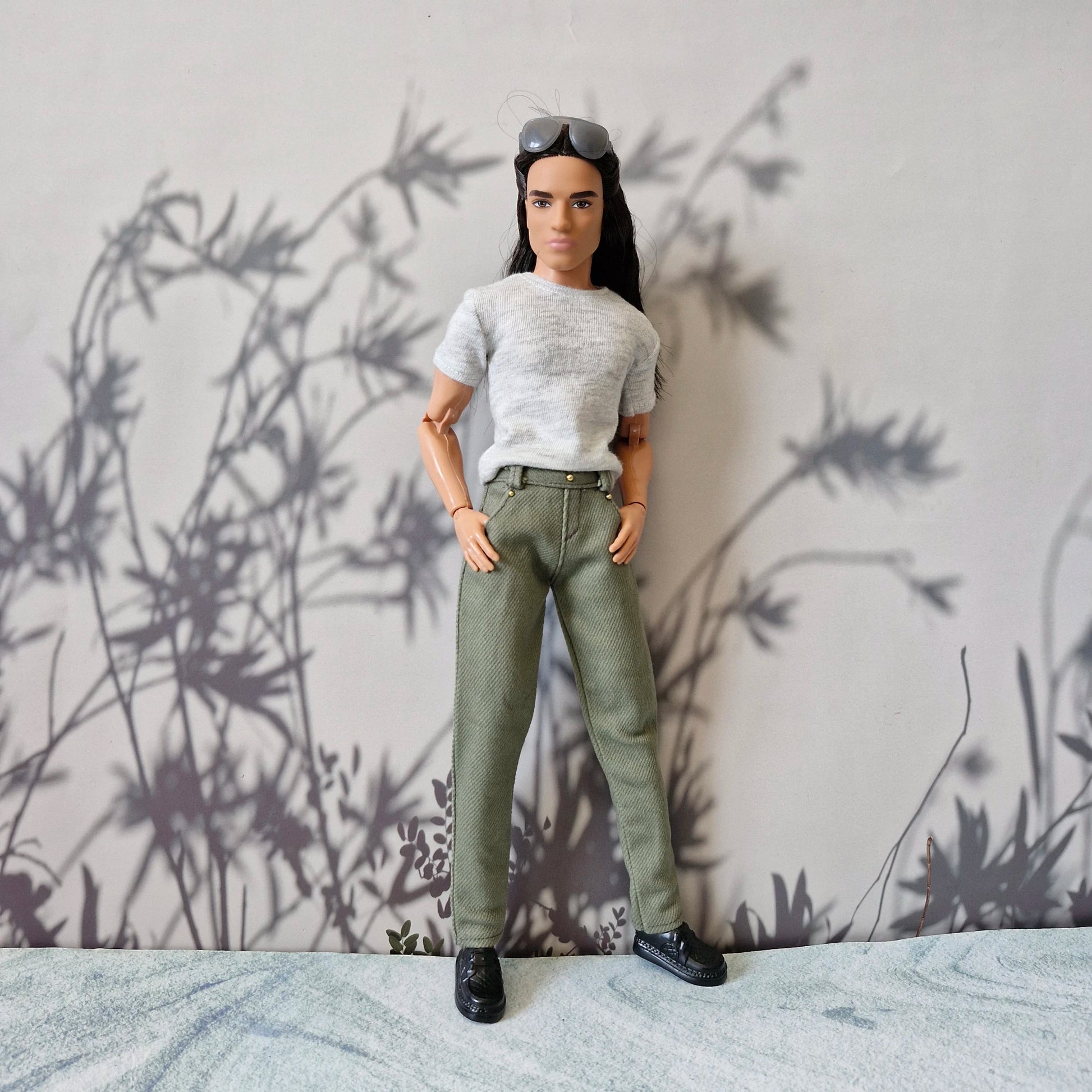 Front view of Ken doll looking stylish in everyday casual grey tee and olive pants