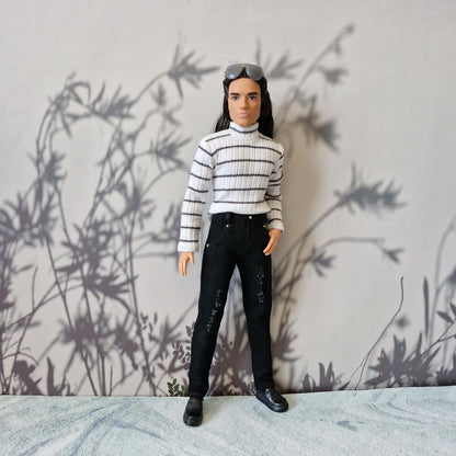 Ken doll looking modern in a striped long sleeve turtleneck top and black denim jeans