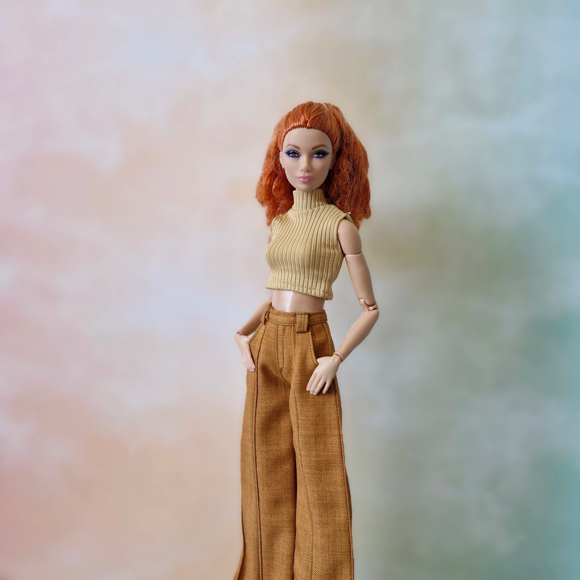 Redhead Barbie doll wearing a tan ribbed sleeveless turtleneck and brown wide-leg pants