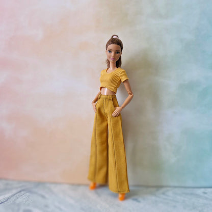 Barbie doll wearing a yellow outfit against a gradient background