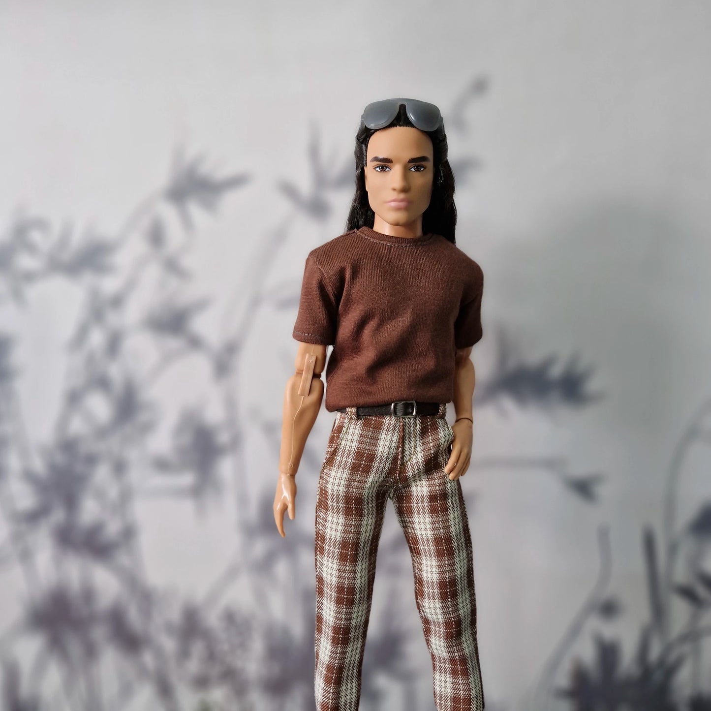 Ken doll (dark skin, short hair) in a basic tee and classic grey trousers streetwear look