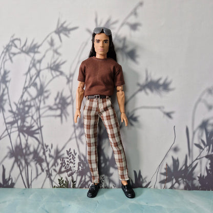 Full length shot of Ken doll wearing a  t-shirt and premium handmade casual grey trousers