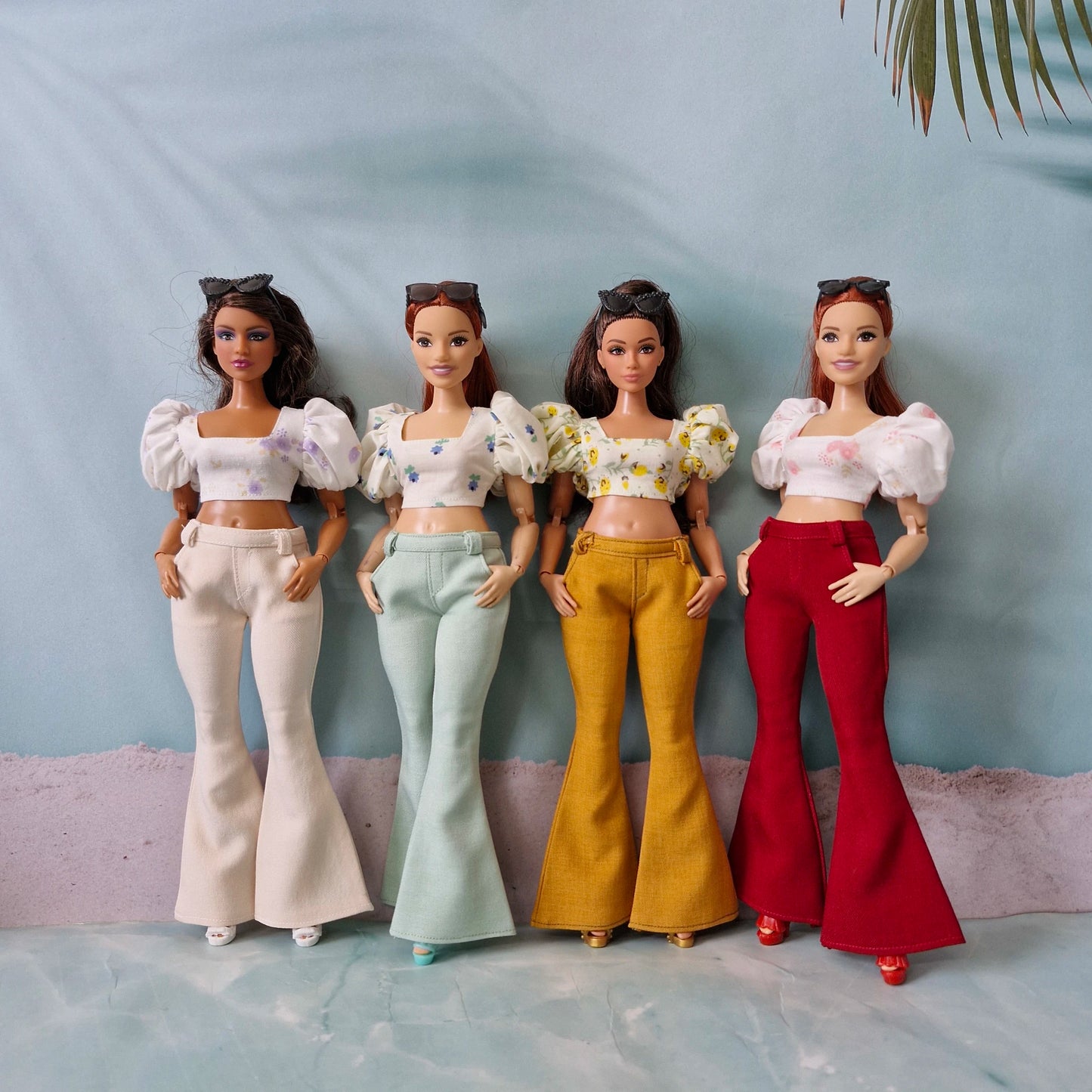 Four Curvy Barbie dolls wearing handmade bell bottom pants and puff sleeve crop tops