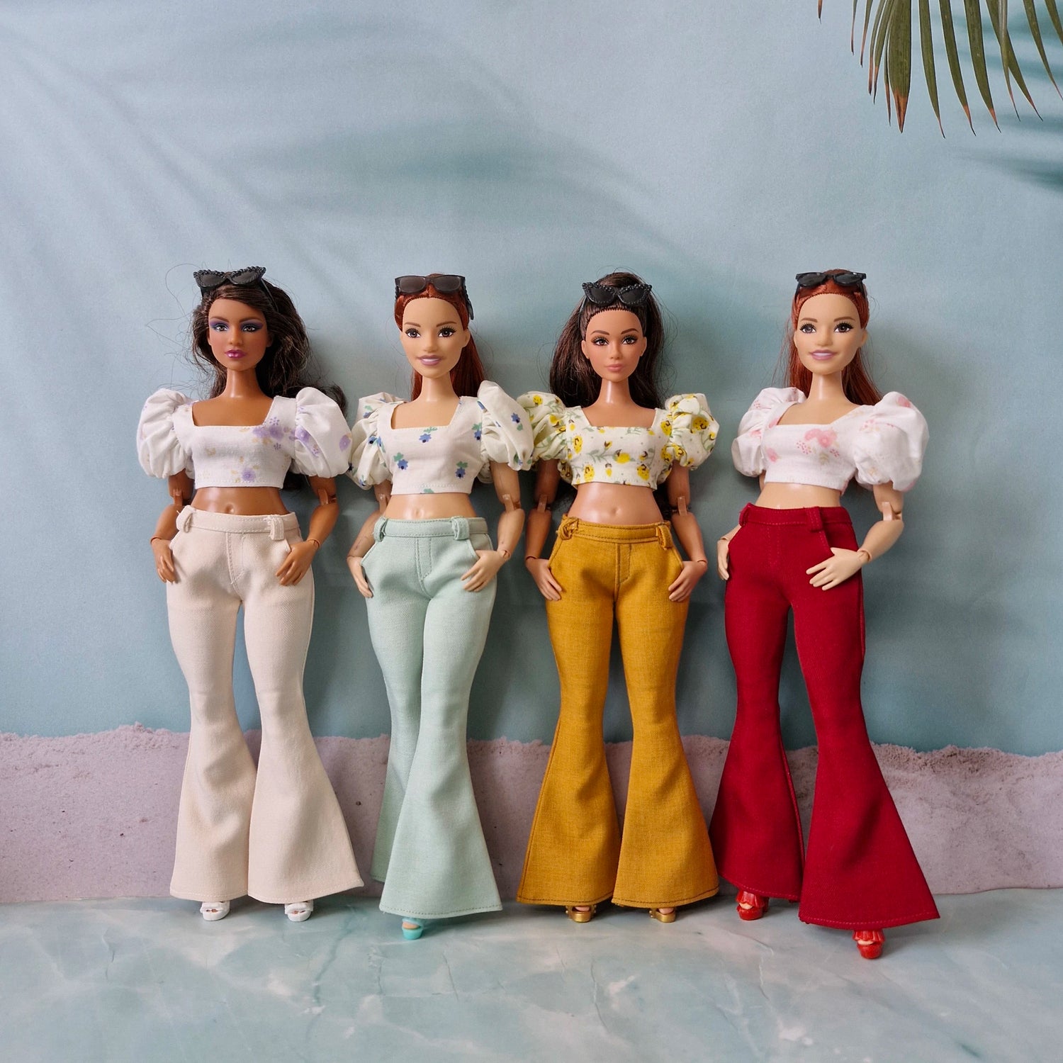 Four Curvy Barbie dolls wearing handmade bell bottom pants and puff sleeve crop tops