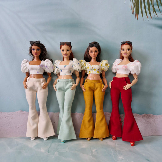 Four Curvy Barbie dolls wearing handmade bell bottom pants and puff sleeve crop tops