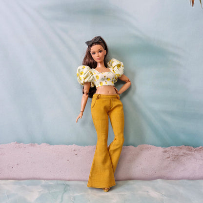 Full body Curvy Barbie fashion outfit with yellow flared pants and floral crop top