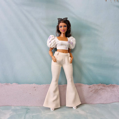 Curvy Barbie doll in ivory white bell bottom pants and lavender floral puff sleeve top