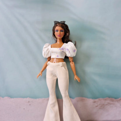 Close up Curvy Barbie outfit with white flared pants and floral crop top