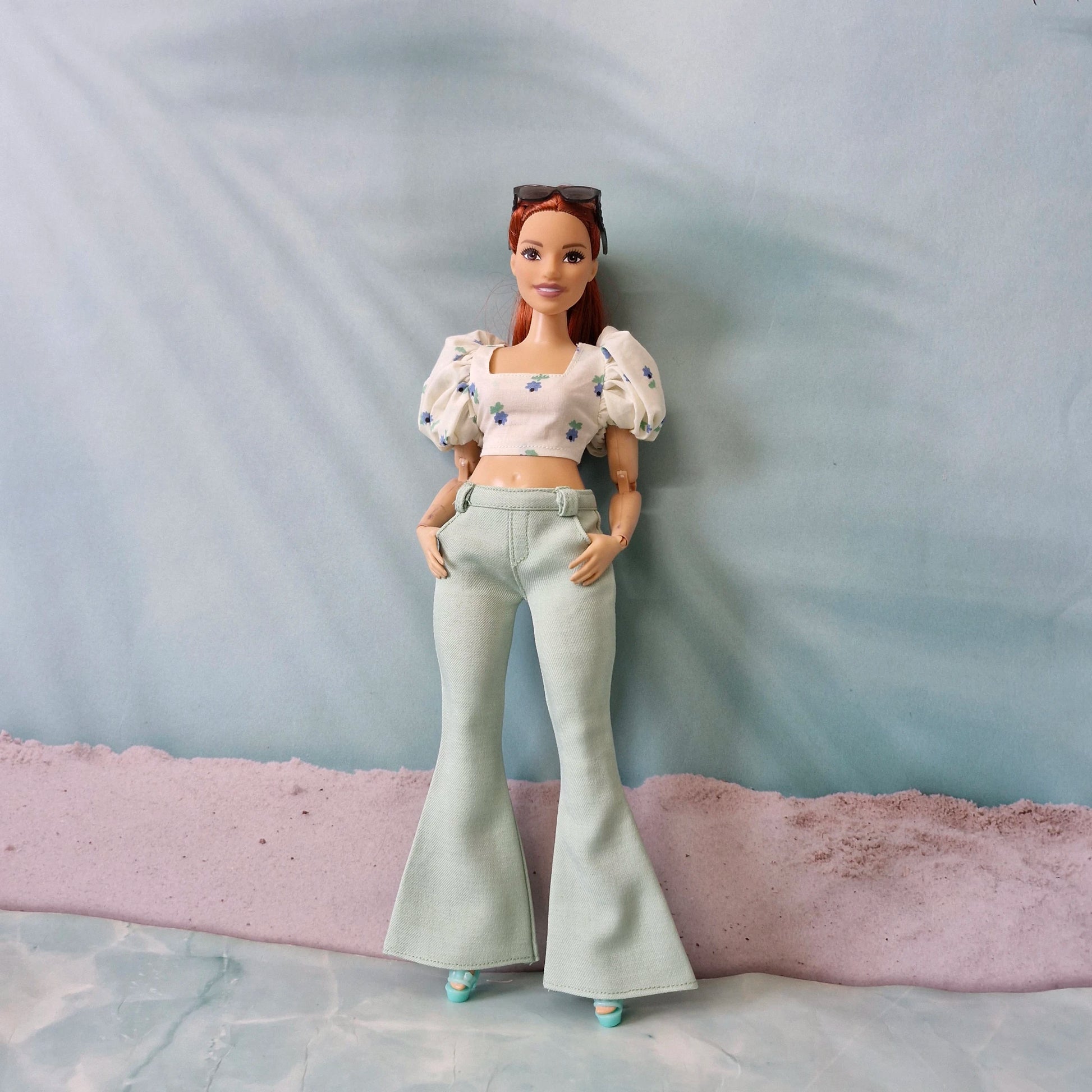 Curvy Barbie doll wearing mint green bell bottom pants and blue floral puff sleeve top
