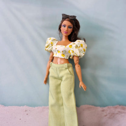 Summer doll fashion featuring a yellow flower print puff sleeve top and pastel green pants designed for Curvy Barbie.