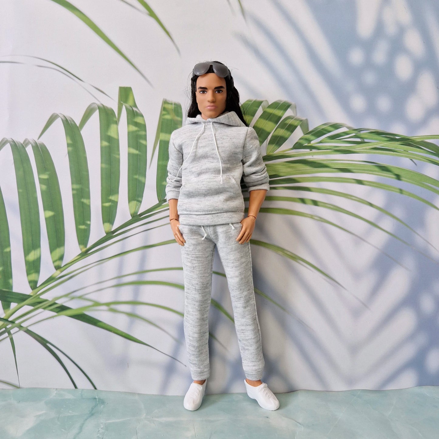 Ken doll dressed in athletic grey loungewear posing casually, showcasing realistic doll streetwear.