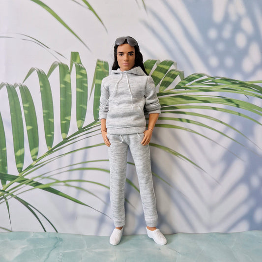 Ken doll dressed in athletic grey loungewear posing casually, showcasing realistic doll streetwear.
