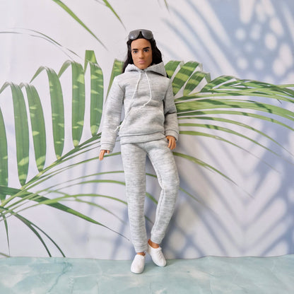 Ken doll fashion featuring a comfortable grey long-sleeve hoodie and jogger pants for miniature styling.