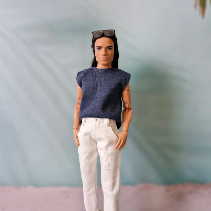 Ken doll modeling a casual navy blue sleeveless t-shirt and white distressed denim jeans.