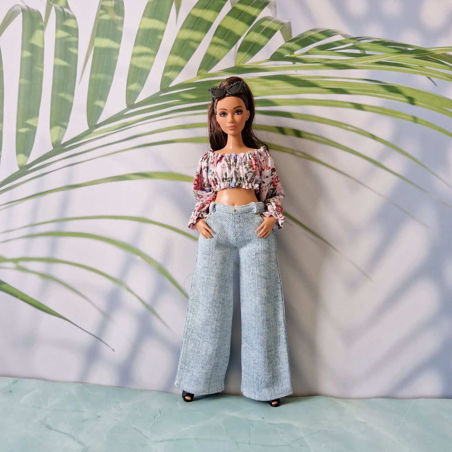 Curvy Barbie fashion featuring a cute floral crop top and trendy light blue wide-leg denim jeans.
