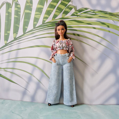 Curvy Barbie fashion featuring a cute floral crop top and trendy light blue wide-leg denim jeans.