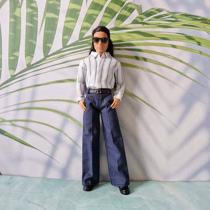 Ken doll wearing black sunglasses, a stylish striped button-down shirt, and tailored navy pants.