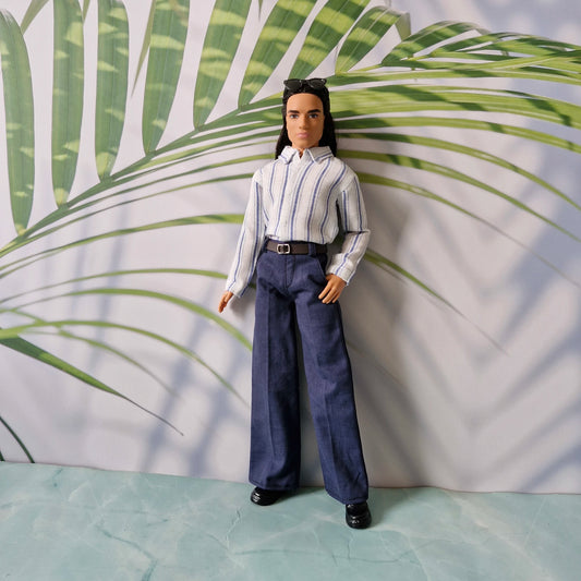 Ken doll wearing a classic white and blue striped button-down shirt tucked into tailored navy trousers with a brown belt.