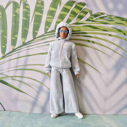 Ken doll wearing a striped hoodie with the hood up, paired with relaxed wide-leg striped pants.