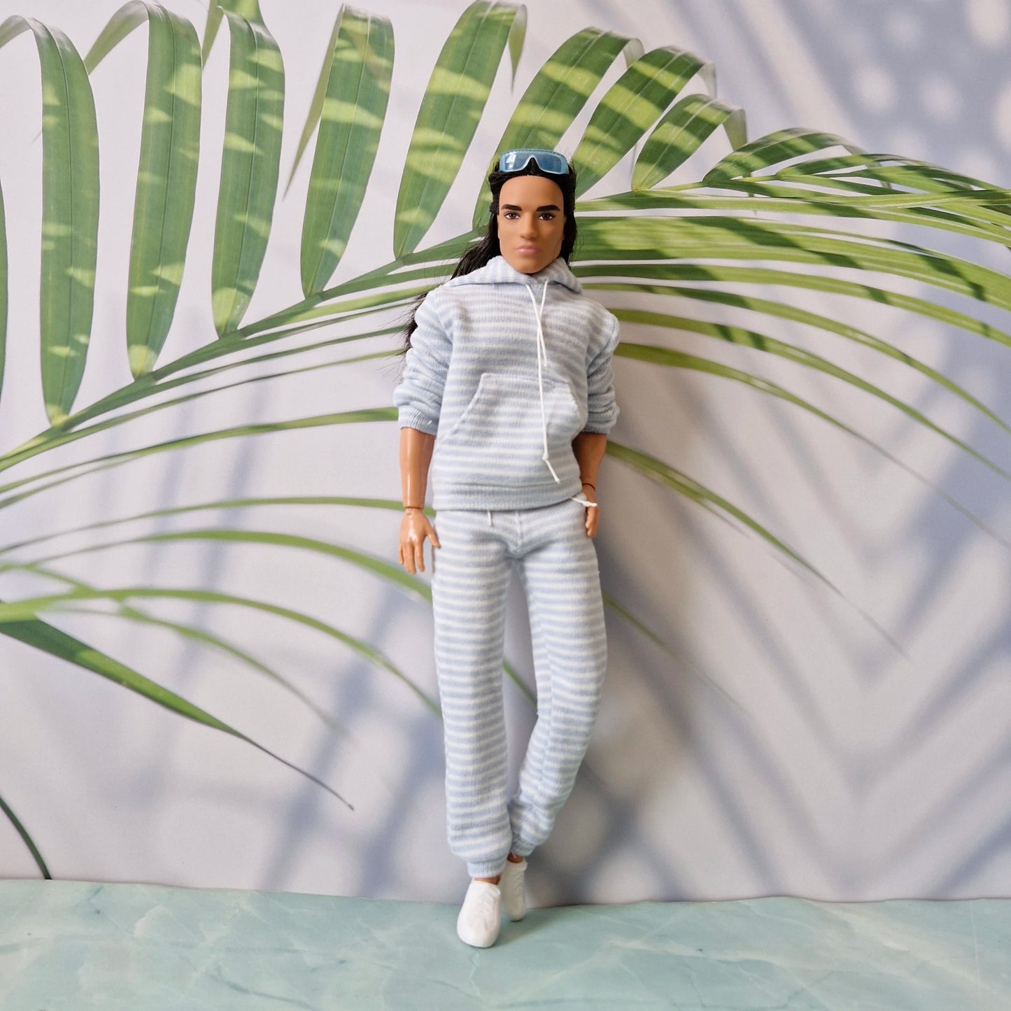 Ken doll fashion featuring a cozy light blue striped tracksuit with hoodie and matching sweatpants.