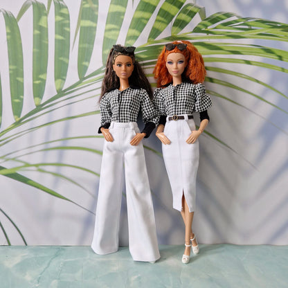 Two fashion dolls showcasing clothes for Barbie: one in white wide-leg pants and the other in a white pencil skirt, both wearing matching gingham tops.