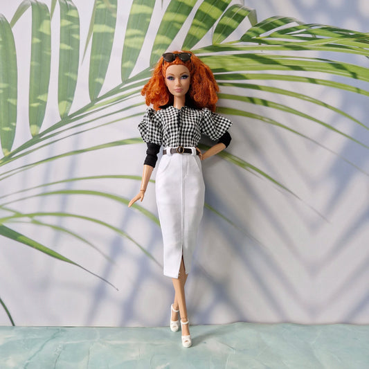 Redhead fashion doll modeling chic clothes for Barbie: a black and white gingham top and a white pencil skirt with a front slit and belt.